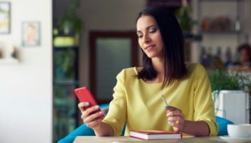 woman holding phone at work